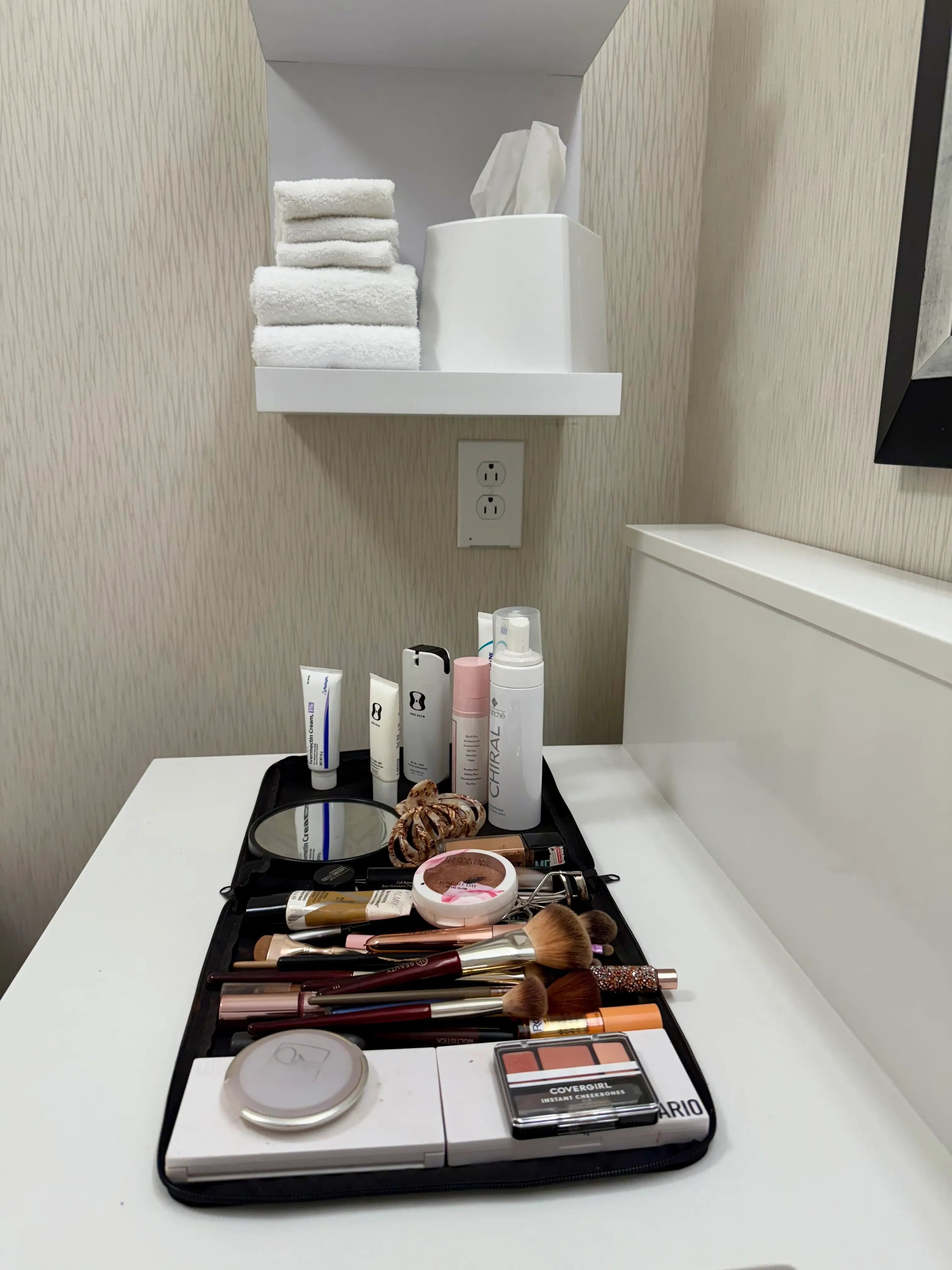 Makeup bag with various items on a bathroom counter